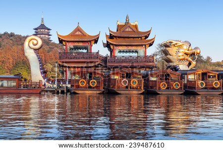 Hangzhou, China - December 5, 2014: Traditional Chinese wooden recreation boats and Dragon ship are moored on the West Lake. Famous park in Hangzhou city center, China