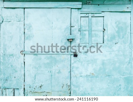 Green rural metal wall  with locked door and window