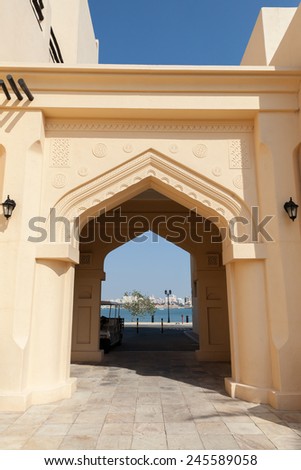 Yellow house facade with classical Arabic style arch, front view