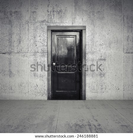 Abstract empty concrete interior with old black wooden door