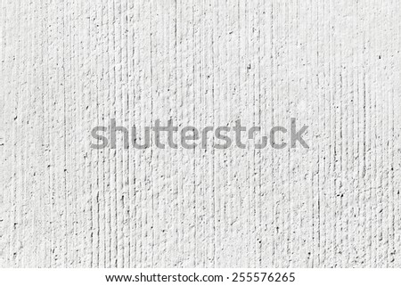 Rough white concrete wall background texture with vertical relief lines