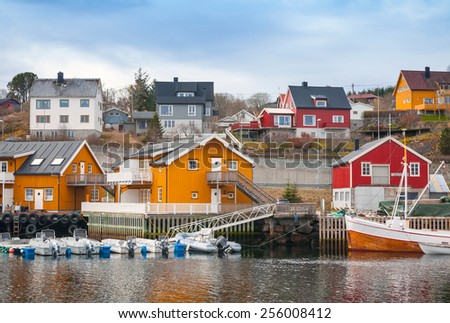 Norwegian fishing village, wooden houses on the sea coast and moored boats