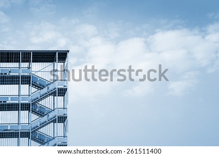 Abstract industrial architecture fragment on blue sky background, metal stairway sections