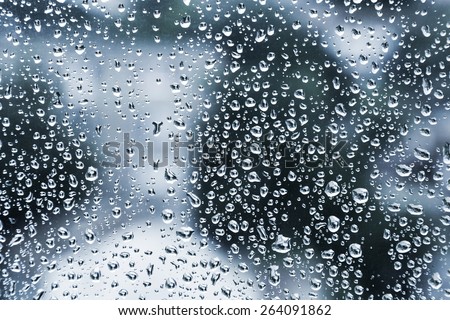 Wet glass with droplets, dark blue photo background with selective focus