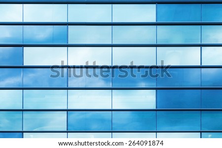 Modern office building wall made of blue glass and steel frame, background texture