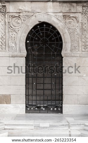 Old locked door with Arabic patterns relief decoration, Konak clock tower, Izmir, Turkey