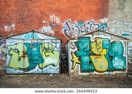 Saint-Petersburg, Russia - April 3, 2015: Old rusted garages with colorful grungy graffiti. Vasilievsky island, Central old part of St. Petersburg city