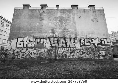 Saint-Petersburg, Russia - April 3, 2015: Graffiti with text on old house wall. Vasilievsky island, Central part of St. Petersburg city. Monochrome photo