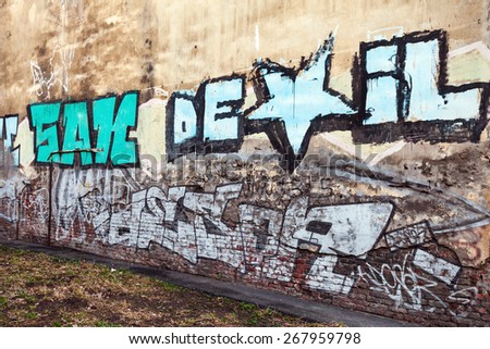 Saint-Petersburg, Russia - April 3, 2015: Graffiti fragment with colorful text on old brick wall. Vasilievsky island, Central part of St. Petersburg city