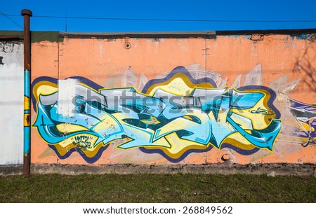 Saint-Petersburg, Russia - April 6, 2015: Colorful graffiti with chaotic text elements over old concrete garage walls