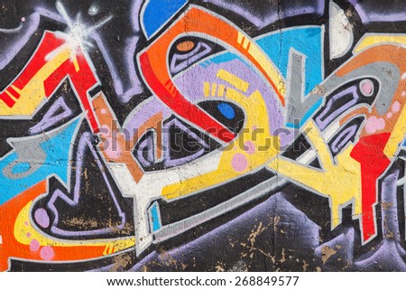 Izmir, Turkey - February 5, 2015: Bright colorful graffiti with chaotic text pattern over old concrete wall
