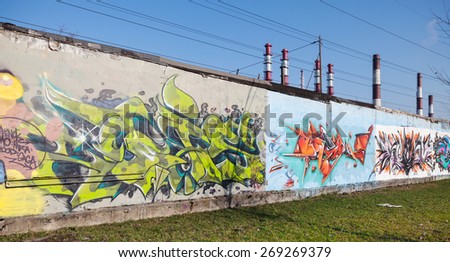 Saint-Petersburg, Russia - April 6, 2015: Colorful graffiti with chaotic patterns and text  on old gray concrete garage walls