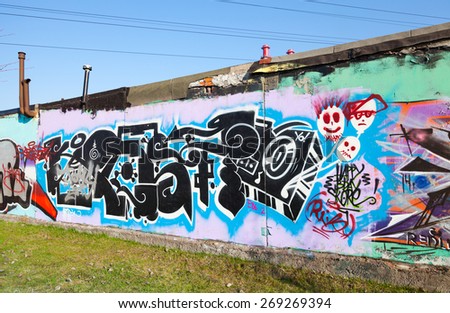 Saint-Petersburg, Russia - April 6, 2015: Graffiti with chaotic patterns and text  on old gray concrete garage walls