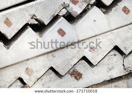 Abstract industrial construction background. Gray concrete stairway elements are stacked outdoor