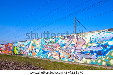 Saint-Petersburg, Russia - April 6, 2015: Abstract colorful text graffiti patterns painted on old gray concrete garage wall