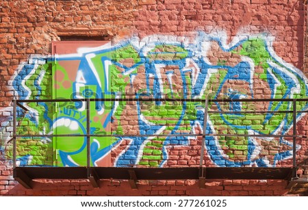 Saint-Petersburg, Russia - April 25, 2015: Urban brick wall with colorful abstract graffiti text pattern. Vasilievsky island, St. Petersburg