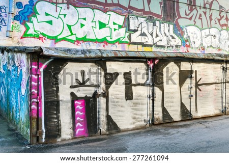 Saint-Petersburg, Russia - May 6, 2015: Old rusted locked abandoned garages with grungy graffiti. Vasilievsky island, Central old part of St. Petersburg city