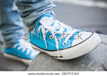 Brand new blue shoes, urban walking theme. Closeup photo with selective focus and shallow DOF