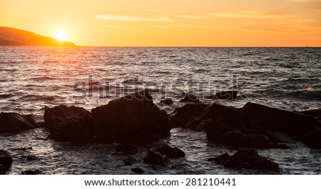 Coastal stones and water, sunset on the Atlantic ocean coast in Morocco, Tangier