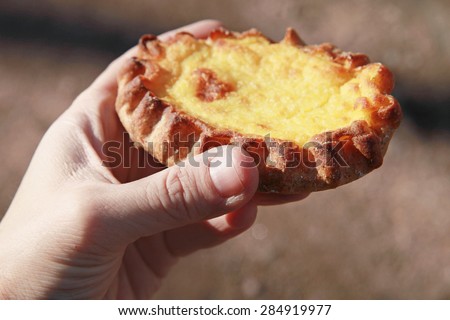 Traditional Karelian pie with rice filling in male hand, closeup photo with selective focus