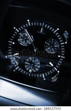 Luxury mens Chronograph Watch made of black high-tech ceramics with sapphire glass. Close-up blue toned studio photo with selective focus