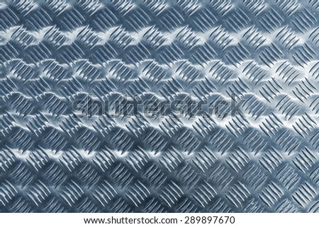 Blue shining metal floor surface with industrial diamond plate relief pattern, blue toned