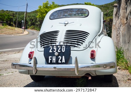 Ajaccio, France - July 6, 2015: Light blue Renault 4CV old-timer economy car stands parked on a roadside in French town, closeup rear view