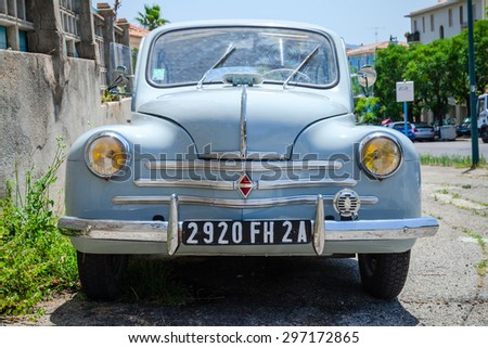Ajaccio, France - July 6, 2015: Light blue Renault 4CV old-timer economy car stands parked on a roadside in French town, front view
