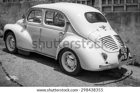 Ajaccio, France - July 6, 2015: White Renault 4CV old-timer economy car stands parked on a roadside in French town, rear view