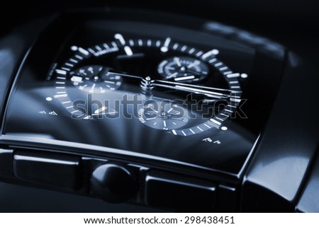 Luxury mens Chronograph Watch made of black high-tech ceramics with sapphire glass. Close-up blue toned studio photo with selective focus