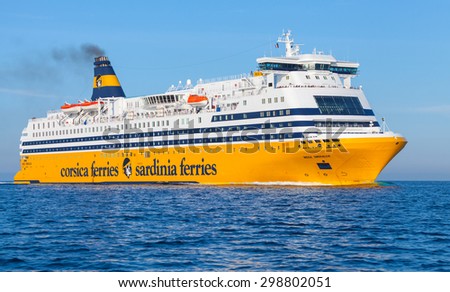Ajaccio, France - June 30, 2015: The Mega Express ferry, big yellow passenger ship operated by Corsica Ferries Sardinia Ferries shipping company goes on Mediterranean Sea