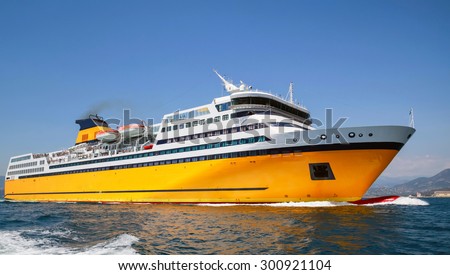 Big yellow passenger ferry goes on the Mediterranean Sea