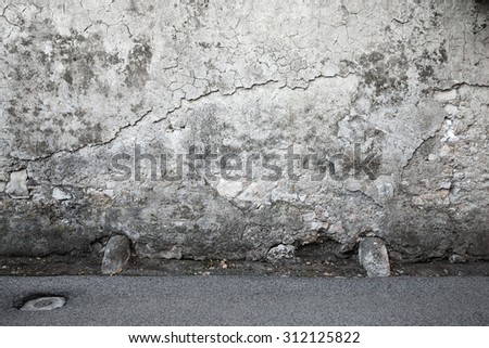 Empty Interior background texture with dark ancient gray stone wall and asphalt road