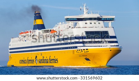 Ajaccio, France - June 30, 2015: Mega Express ferry, big yellow passenger ship operated by Corsica Ferries Sardinia Ferries shipping company goes on Mediterranean Sea