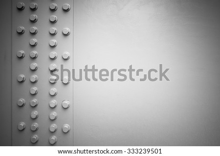 White steel wall with bolts, metal parts connection, background with vignette shadow effect