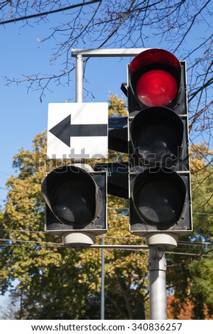 City traffic light with side section and arrow shows red stop signal