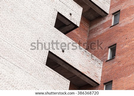 Abstract urban architecture fragment, gray and red brick walls with balcony and windows