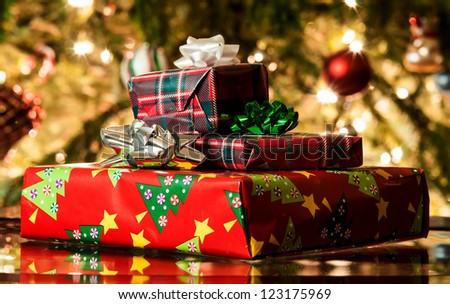 different present boxes under Christmas tree in holiday eve, Christmastime celebration, home decorated with festive shiny balls, magic x-mas night