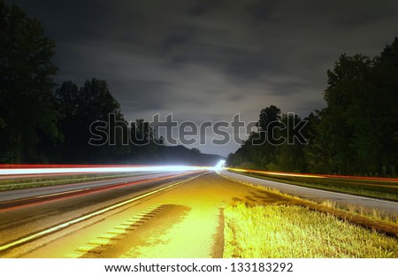 highway traffic at night between the exit ramp