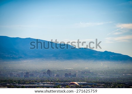Albuquerque new mexico skyline in smog  with mountains