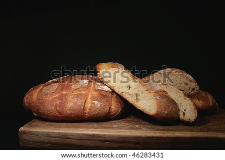 photo of handmade bread on black background