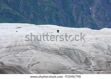 People hiking on a glacier in Alaska