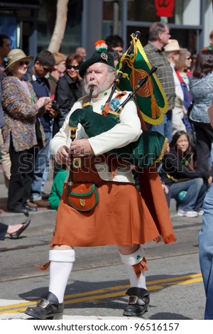 SAN FRANCISCO, CA - MARCH 12: A man dressed in Irish kilt plays uilleann pipes - a traditional Irish musical instrument during the St. Patric\'s Day Parade March 12, 2011 in San Francisco, CA