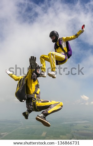 Two sports parachutist build a figure in free fall.