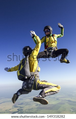Two parachutists girls in free fall.
