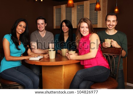 Diverse Group of Friends Bible Study in Cafe
