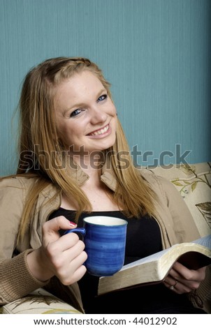 Beautiful Young Woman with morning coffee and bible