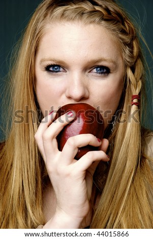 Beautiful Woman biting into red apple
