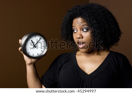 Nervous Young Woman looking at the clock