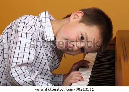 young boy gets piano lesson